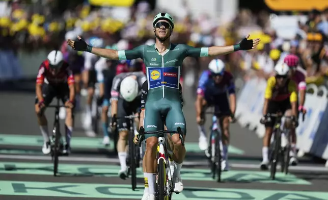 Italy's Jonathan Milan, wearing the best sprinter's green jersey, celebrates as he crosses the finish line to win the eighth stage of the Tour de France cycling race over 171.4 kilometers (106.5 miles) with start in Saint-Meen-le-Grand and finish in Laval Espace Mayenne, France, Saturday, July 12, 2025. (AP Photo/Mosa'ab Elshamy)