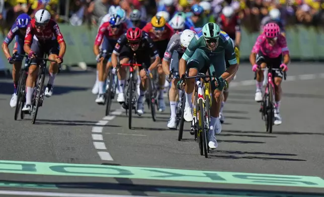 Italy's Jonathan Milan, wearing the best sprinter's green jersey, crosses the finish line to win the eighth stage of the Tour de France cycling race over 171.4 kilometers (106.5 miles) with start in Saint-Meen-le-Grand and finish in Laval Espace Mayenne, France, Saturday, July 12, 2025. (AP Photo/Mosa'ab Elshamy)