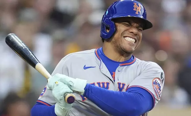 New York Mets' Juan Soto reacts after fouling a ball off his leg while batting during the fourth inning of a baseball game against the San Diego Padres Tuesday, July 29, 2025, in San Diego. (AP Photo/Gregory Bull)