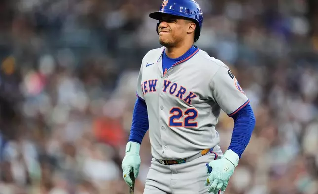 FILE - New York Mets' Juan Soto reacts after fouling a ball off his left foot in the fourth inning of a baseball game against the San Diego Padres,Tuesday, July 29, 2025, in San Diego. (AP Photo/Gregory Bull, File)