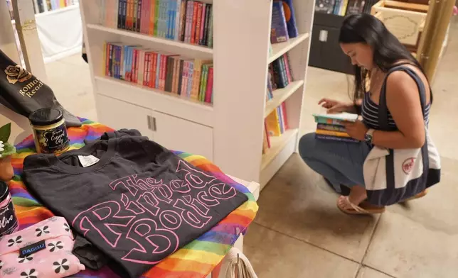 Keiana Samoy browses romance titles at The Ripped Bodice bookstore in Culver City, Calif., on Thursday, July 3, 2025. (AP Photo/Chris Pizzello)