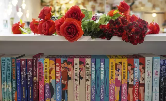 Roses are displayed atop a bookshelf of romance titles at The Ripped Bodice bookstore in Culver City, Calif., on Thursday, July 3, 2025, (AP Photo/Chris Pizzello)