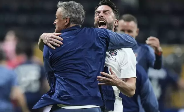 Paris Saint-Germain manager Luis Enrique celebrates with coaches after the Club World Cup quarterfinal soccer match between PSG and Bayern Munich in Atlanta, Saturday, July 5, 2025. (AP Photo/Mike Stewart)