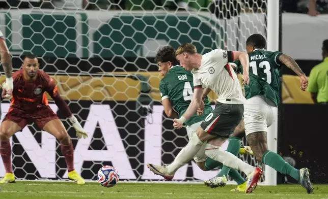 Chelsea's Cole Palmer, front, scores his side's opening goal against Palmeiras during the Club World Cup quarterfinal soccer match between Palmeiras and Chelsea in Philadelphia, Friday, July 4, 2025. (AP Photo/Chris Szagola)