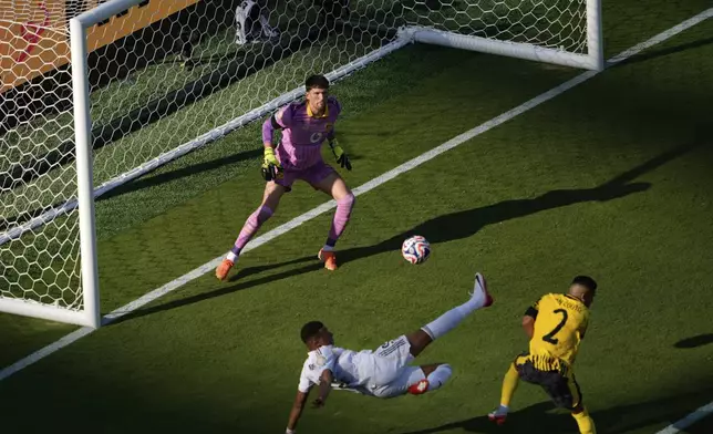 Real Madrid's Kylian Mbappe, bottom, scores his side's 3rd goal during the Club World Cup quarterfinal soccer match between Real Madrid and Borussia Dortmund in East Rutherford, N.J., Saturday, July 5, 2025. (AP Photo/Pamela Smith)
