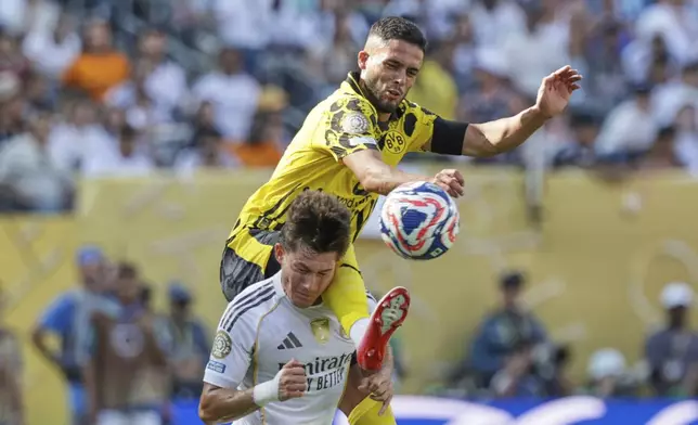 Borussia Dortmund's Yan Couto, top, and Real Madrid's Fran Garcia battle for the ball during the Club World Cup quarterfinal soccer match between Real Madrid and Borussia Dortmund in East Rutherford, N.J., Saturday, July 5, 2025. (AP Photo/Adam Hunger)