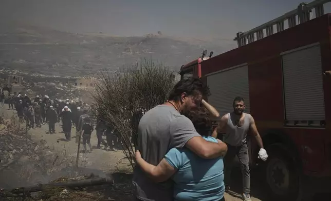 Druze from Syria and Israel protest on the Israeli-Syrian border, in Majdal Shams in the Israeli-controlled Golan Heights, Wednesday, July 16, 2025, amid the ongoing clashes between Syrian government forces and Druze armed groups in the southern Syrian city of Sweida. (AP Photo/Leo Correa)