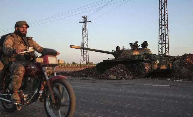 Syrian government forces deploy at Mazraa village on the outskirts of the city of Sweida, where clashes erupted between Sunni Bedouin clans and Druze militias, southern Syria, Monday, July 14, 2025. (AP Photo/Ghaith Alsayed)