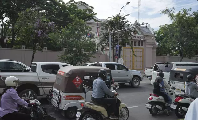 Local vehicles pass the Thai Embassy in Phnom Penh, Cambodia, Thursday, July 24, 2025. (AP Photo/Heng Sinith)