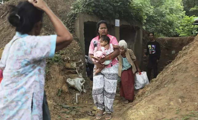 Thai people who fled clashes between Thai and Cambodian soldiers take shelter in Surin province, northeastern Thailand, Thursday, July 24, 2025. (AP Photo/Sunny Chittawil)