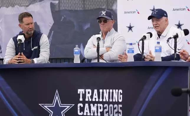 Jerry Jones, right, Dallas Cowboys owner, president, and general manager speaks to reporters as Cowboys head coach Brian Schottenheimer, left, and Stephen Jones, Dallas Cowboys co-owner, executive vice president, CEO, and director of player personnel listen during a news conference to open training camp Monday, July 21, 2025, in Oxnard, Calif. (AP Photo/Mark J. Terrill)