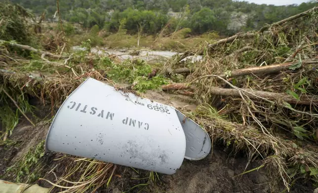 A Camp Mystic mailbox lies near the entrance to the camp along the banks of the Guadalupe River, Saturday, July 5, 2025, in Hunt, Texas, after a flash flood swept through the area. (AP Photo/Julio Cortez)
