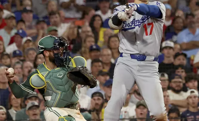 Los Angeles Dodgers designated hitter Shohei Ohtani (17) strikes out during the seventh inning of a baseball game against the Boston Red Sox, Friday, July 25, 2025, in Boston. (AP Photo/Mark Stockwell)