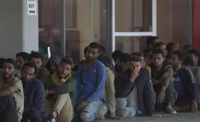 Migrants rescued south of Crete wait to be registered on their arrival at the the port of Lavrio, Greece, on Thursday, July 10, 2025. (AP Photo/Petros Giannakouris)