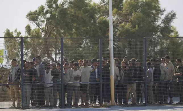 Migrants rescued south of Crete wait to be registered on their arrival at the the port of Lavrio, Greece, on Thursday, July 10, 2025. (AP Photo/Petros Giannakouris)