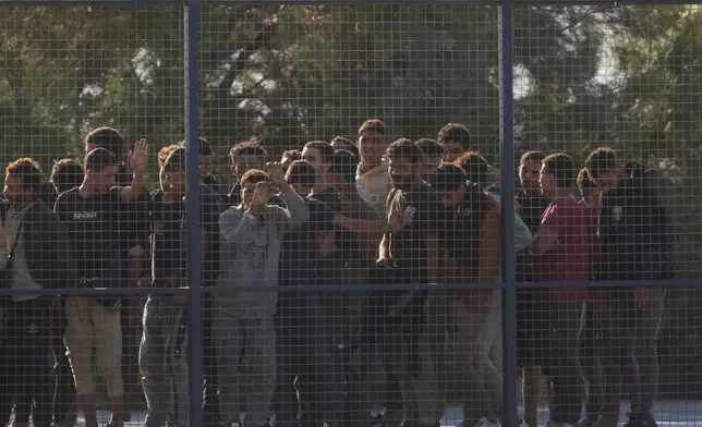 Migrants rescued south of Crete wait to be registered on their arrival at the the port of Lavrio, Greece, on Thursday, July 10, 2025. (AP Photo/Petros Giannakouris)