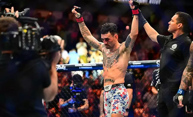 Max Holloway celebrates after winning the lightweight title fight at UFC 318 in New Orleans, La., Saturday, July 19, 2025. (AP Photo/Ella Hall)