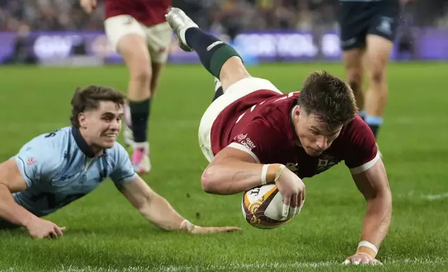 Huw Jones of the British &amp; Irish Lions scores a try during the Lions and Waratahs rugby match, in Sydney, Australia, Saturday, July 5, 2025. (AP Photo/Rick Rycroft)