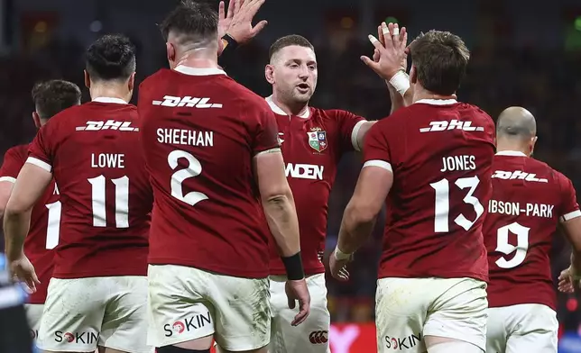 Jack Conan of the British &amp; Irish Lions, center, celebrates with teammates after their win over Australia in their first rugby union test in Brisbane, Australia, Saturday, July 19, 2025. (AP Photo/Pat Hoelscher)