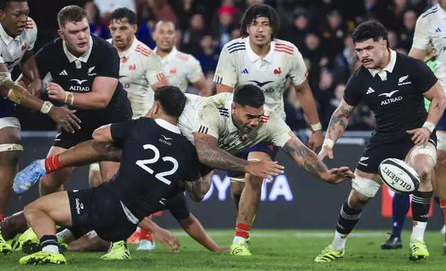 Romain Taofifenua of France loses the ball forward as he is tackled by New Zeakand's Quinn Tupaea during their rugby test in Dunedin, New Zealand, Saturday, July 5, 2025. (Marty Melville/Photosport via AP)