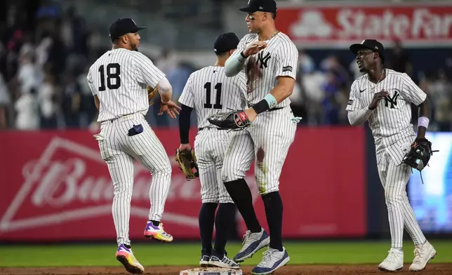 New York Yankees players, including outfielder Aaron Judge, second from right, celebrate after winning a baseball game against the Chicago Cubs, Friday, July 11, 2025, in New York. (AP Photo/Yuki Iwamura)