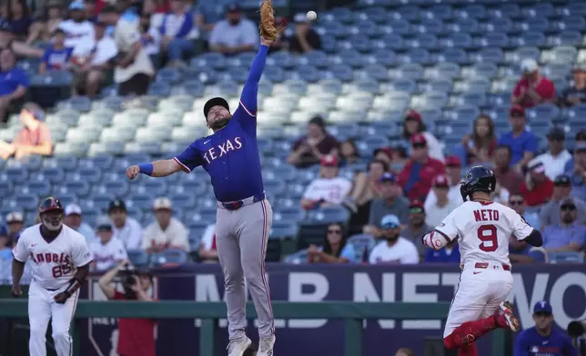 Los Angeles Angels' Zach Neto is safe at first as Texas Rangers first baseman Jake Burger misses the throw during the first inning of a baseball game Tuesday, July 8, 2025 in Anaheim, Calif. (AP Photo/Mark J. Terrill)