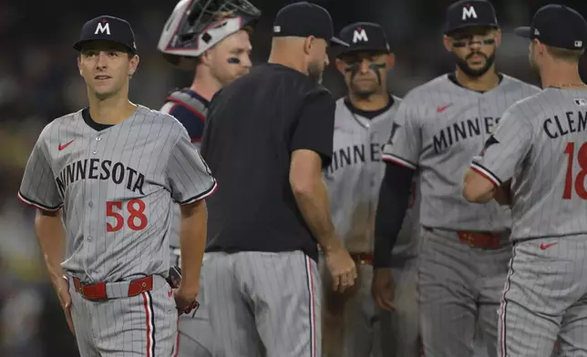 Minnesota Twins starting pitcher David Festa, left, walks off the mound as he is pulled by Twins' manager Rocco Baldelli during the sixth inning of a baseball game, against the Los Angeles Dodgers, Monday, July 21, 2025, in Los Angeles. (AP Photo/Jayne Kamin-Oncea)