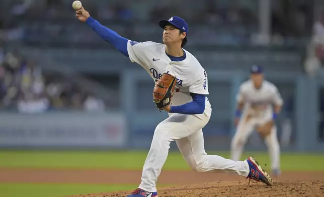 Los Angeles Dodgers pitcher Shohei Ohtani throws against the Minnesota Twins during the third inning of a baseball game in Los Angeles, Monday, July 21, 2025. (AP Photo/Jayne Kamin-Oncea)