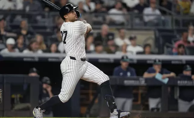 New York Yankees designated hitter Giancarlo Stanton (27) hits a two-run home run during the sixth inning of a baseball game against the Seattle Mariners, Tuesday, July 8, 2025, in New York. (AP Photo/Yuki Iwamura)