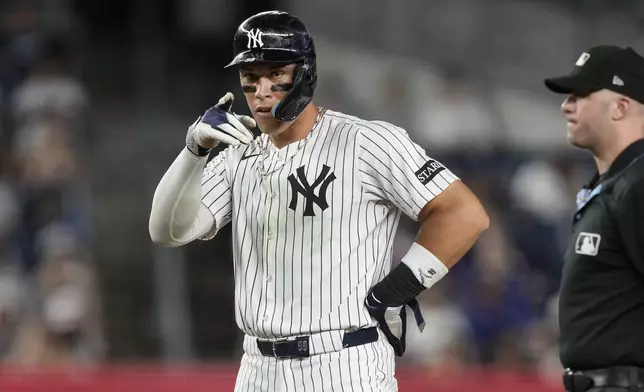 New York Yankees' Aaron Judge (99) reacts after hitting a single during the sixth inning of a baseball game against the Seattle Mariners, Tuesday, July 8, 2025, in New York. (AP Photo/Yuki Iwamura)