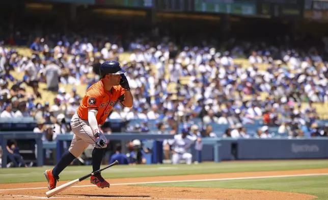 Houston Astros' Jose Altuve drops his bat after hitting a single during the first inning of a baseball game against the Los Angeles Dodgers, Sunday, July 6, 2025, in Los Angeles. (AP Photo/Jessie Alcheh)