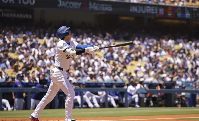 Los Angeles Dodgers designated hitter Shohei Ohtani watches his fly ball during the first inning of a baseball game against the Houston Astros, Sunday, July 6, 2025, in Los Angeles. (AP Photo/Jessie Alcheh)