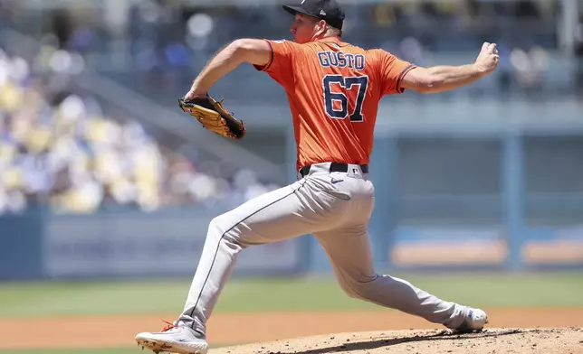 Houston Astros pitcher Ryan Gusto throws to a Los Angeles Dodgers batter during the first inning of a baseball game Sunday, July 6, 2025, in Los Angeles. (AP Photo/Jessie Alcheh)