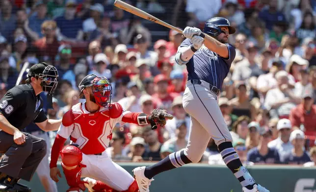 Tampa Bay Rays' Josh Lowe hits a sacrifice fly to score outfielder Jake Mangum in the fourth inning of a baseball game, Sunday, July 13, 2025, in Boston. (AP Photo/Greg M. Cooper)