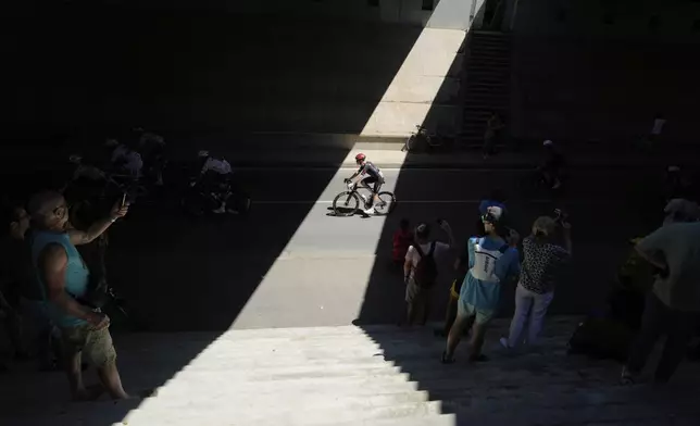 Spectators take photos of the riders during the eleventh stage of the Tour de France cycling race over 156.8 kilometers (97.4 miles) with start and finish in Toulouse, France, Wednesday, July 16, 2025. (AP Photo/Mosa'ab Elshamy)