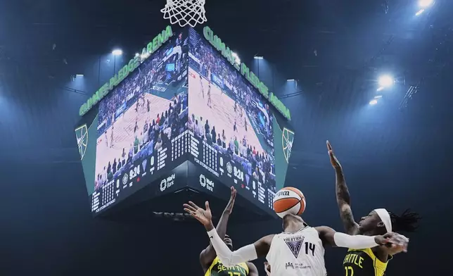 Golden State Valkyries center Temi Fagbenle (14) loses the ball against Seattle Storm forward Ezi Magbegor (13) and guard Erica Wheeler, right, during the first half of a WNBA basketball game Wednesday, July 16, 2025, in Seattle. (AP Photo/Lindsey Wasson)