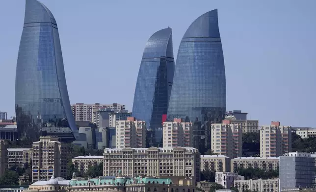 FILE - The Old City stands with the Flame Towers skyscrapers in background in Baku, Azerbaijan, June 13, 2021. (AP Photo/Darko Vojinovic, File)