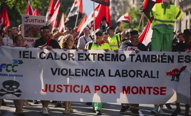FILE - People march in Barcelona to protest the death of street cleaner Montse Aguilar during a recent heat wave in Spain, Wednesday, July 16, 2025. The banner in Spanish reads, “Extreme Heat is also Workplace Violence. Justice for Montse." (AP Photo/Joan Mateu Parra, File)