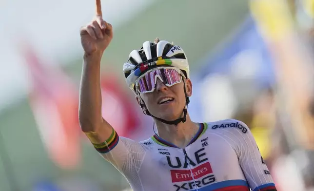 Slovenia's Tadej Pogacar crosses the finish line to win the twelfth stage of the Tour de France cycling race over 180.6 kilometers (112.2 miles) with start in Auch and finish in Hautacam, France, Thursday, July 17, 2025. (AP Photo/Mosa'ab Elshamy)