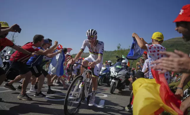 Slovenia's Tadej Pogacar climbs towards Hautacom to win the twelfth stage of the Tour de France cycling race over 180.6 kilometers (112.2 miles) with start in Auch and finish in Hautacam, France, Thursday, July 17, 2025. (AP Photo/Thibault Camus)
