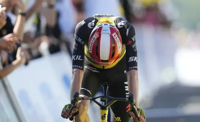 Denmark's Jonas Vingegaard crosses the finish line in second position, losing time on his adversary Slovenia's Tadej Pogacar during the twelfth stage of the Tour de France cycling race over 180.6 kilometers (112.2 miles) with start in Auch and finish in Hautacam, France, Thursday, July 17, 2025. (AP Photo/Mosa'ab Elshamy)