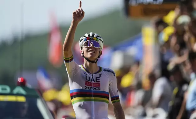 Slovenia's Tadej Pogacar crosses the finish line to win the twelfth stage of the Tour de France cycling race over 180.6 kilometers (112.2 miles) with start in Auch and finish in Hautacam, France, Thursday, July 17, 2025. (AP Photo/Mosa'ab Elshamy)