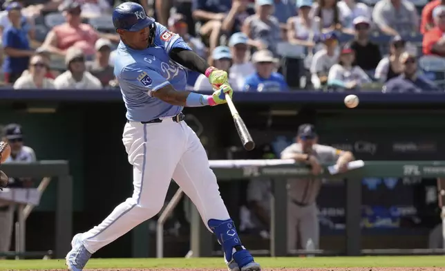 Kansas City Royals' Salvador Perez hits an RBI single to win the baseball game during the 10th inning against the Atlanta Braves, Wednesday, July 30, 2025, in Kansas City, Mo. (AP Photo/Charlie Riedel)