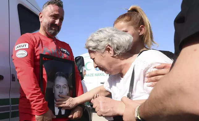 Relatives and friends mourn during the funeral of five rescue volunteers killed while battling a wildfire in northwestern Eskisehir province, in Ankara, Turkey, Thursday, July 24, 2025. (Yavuz Ozden/Dia Photo via AP)
