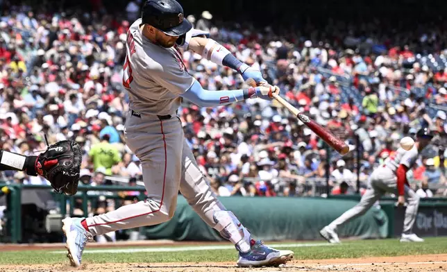 Boston Red Sox's Trevor Story singles in two runs during the fifth inning of a baseball game against the Washington Nationals, Friday, July 4, 2025, in Washington. (AP Photo/Nick Wass)
