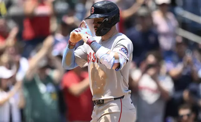 Boston Red Sox's Trevor Story celebrates his two-run home run during the eighth inning of a baseball game against the Washington Nationals, Friday, July 4, 2025, in Washington. (AP Photo/Nick Wass)