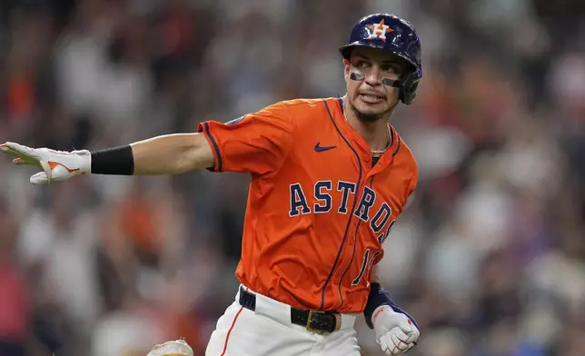 Houston Astros' Mauricio Dubón celebrates after hitting a home run against the Texas Rangers during the seventh inning of a baseball game Saturday, July 12, 2025, in Houston. (AP Photo/David J. Phillip)