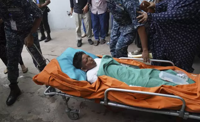 An injured victim in the Bangladesh Air Force aircraft crash lies on a stretcher at a hospital in Dhaka, Bangladesh, Monday, July 21, 2025. (AP Photo/Ahadul Karim Khan)