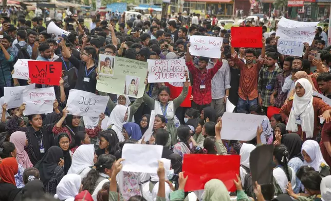 Students shout slogans during a protest near the site of the Monday crash of a Bangladesh air force training jet into a school, demanding accountability, compensation for victims' families and the halt of training flights, in Dhaka, Bangladesh, Tuesday, July 22, 2025. (AP Photo/ Mehedi Hasan)