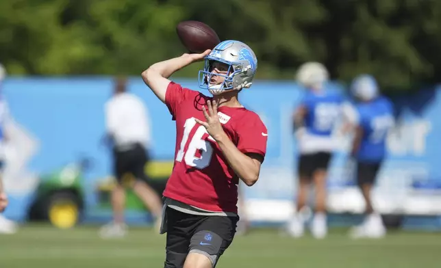Detroit Lions quarterback Jared Goff (16) throws after an NFL football practice in Allen Park, Mich., Tuesday, July 22, 2025. (AP Photo/Paul Sancya)